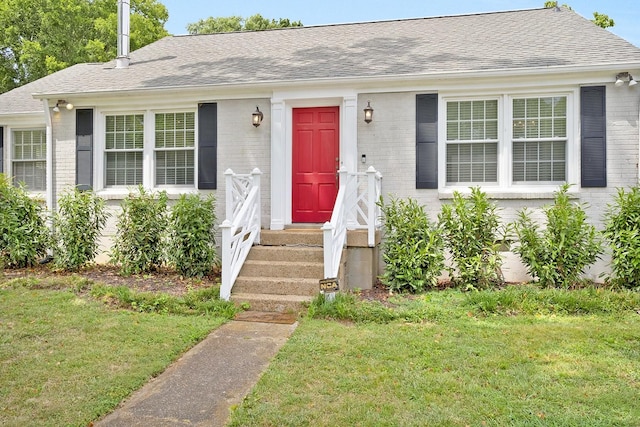 single story home featuring a front yard