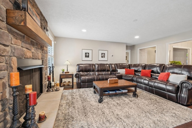 living room with a fireplace and a textured ceiling