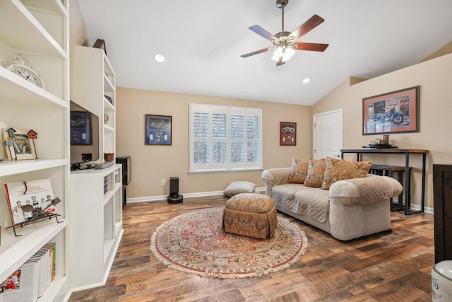 living room with dark hardwood / wood-style floors, ceiling fan, and vaulted ceiling