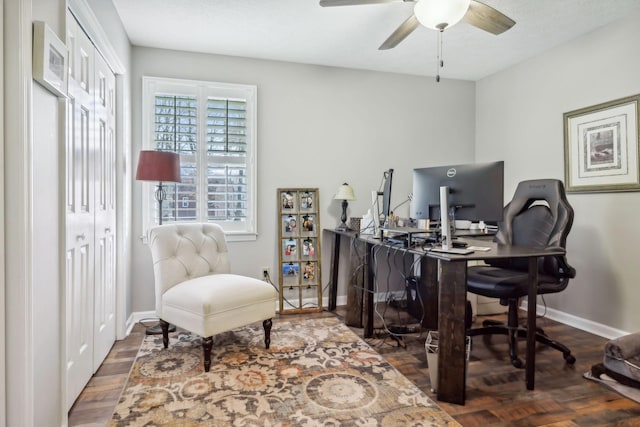 home office with ceiling fan and dark wood-type flooring