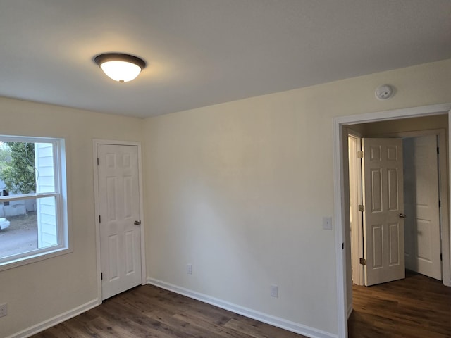 empty room with dark wood-type flooring