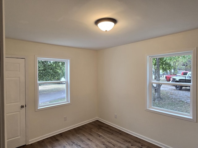 unfurnished room featuring dark hardwood / wood-style flooring