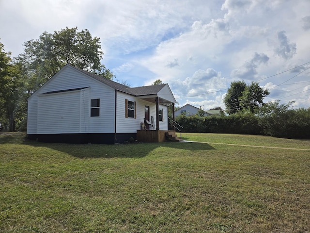 view of front of house with a front yard, a garage, and an outdoor structure