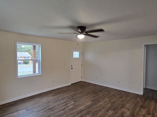 interior space with a wealth of natural light and dark wood-type flooring