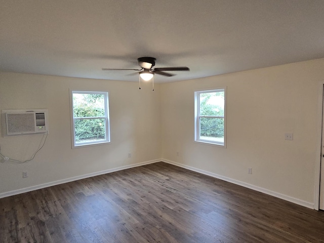 empty room featuring dark hardwood / wood-style floors, ceiling fan, and an AC wall unit