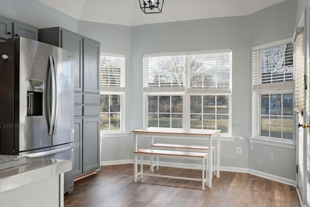 kitchen with gray cabinetry, stainless steel fridge, a healthy amount of sunlight, and dark hardwood / wood-style floors