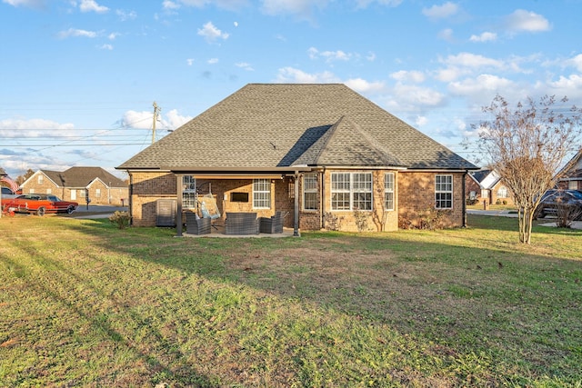 back of property featuring a lawn