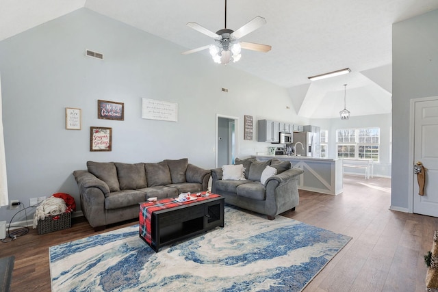 living room featuring ceiling fan, hardwood / wood-style floors, and high vaulted ceiling