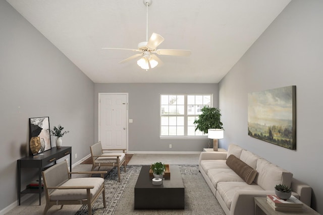 carpeted living room with ceiling fan and vaulted ceiling