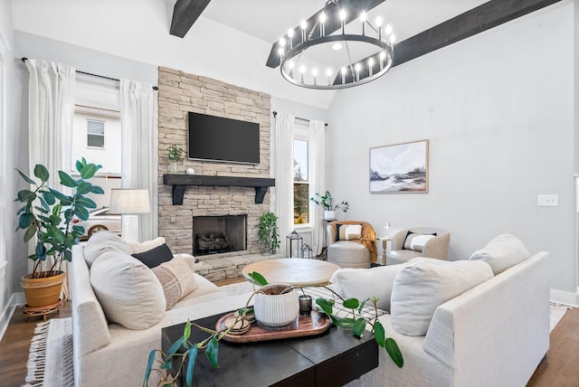 living room with beam ceiling, a healthy amount of sunlight, dark wood-type flooring, and a fireplace