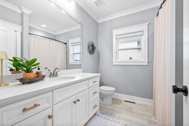 bathroom with vanity, toilet, and crown molding