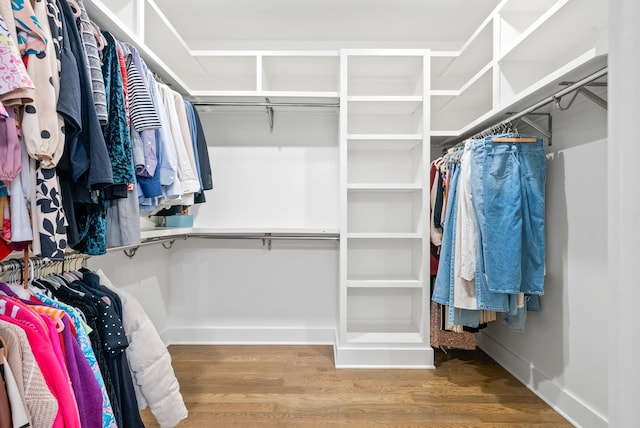 walk in closet with hardwood / wood-style floors