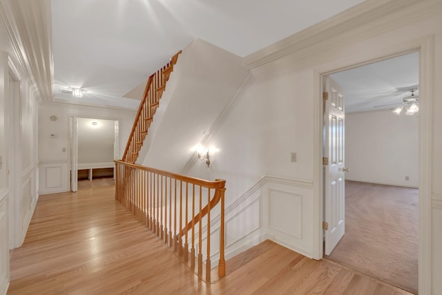 hall featuring light carpet and crown molding