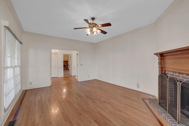 unfurnished living room with a fireplace, light hardwood / wood-style floors, ceiling fan, and ornamental molding