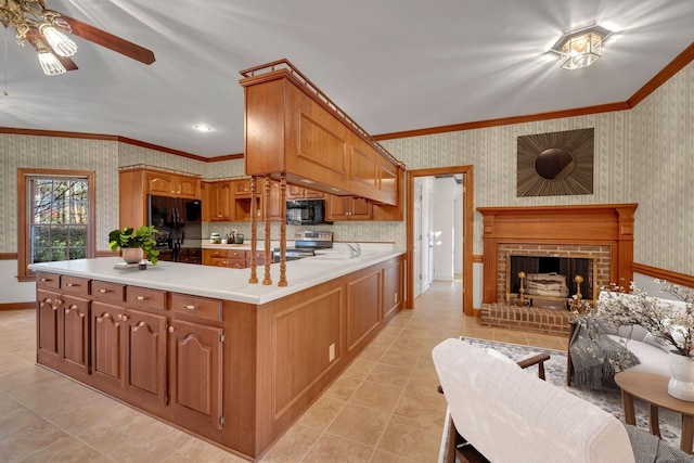 kitchen with black appliances, crown molding, ceiling fan, light tile patterned floors, and a fireplace