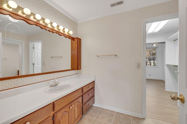 bathroom with tile patterned flooring, vanity, and ornamental molding