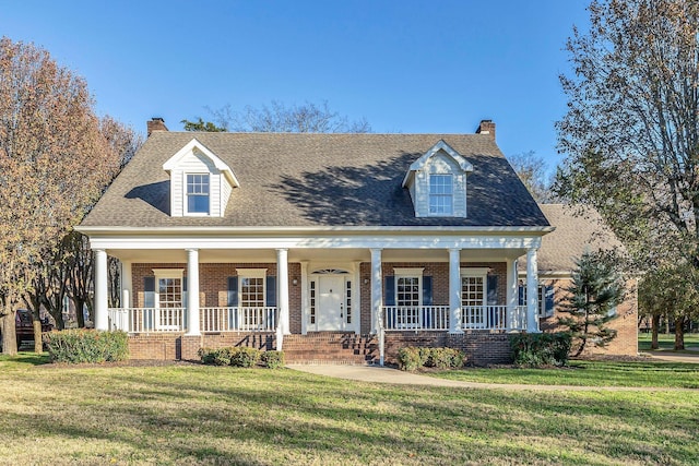 cape cod house featuring a porch and a front lawn