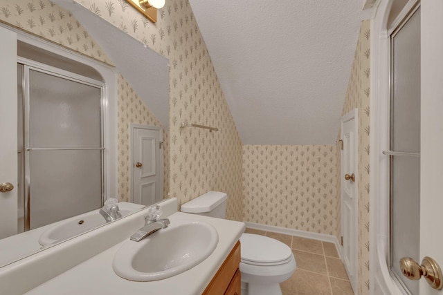 bathroom with tile patterned flooring, vanity, an enclosed shower, and toilet