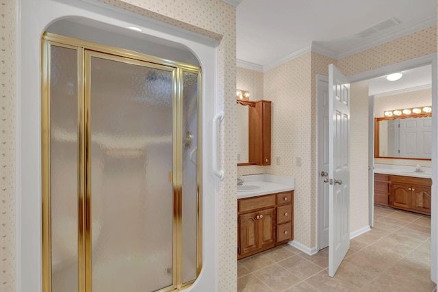 bathroom with tile patterned floors, vanity, a shower with shower door, and ornamental molding