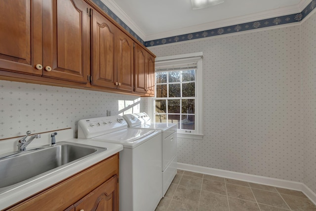 laundry room with cabinets, sink, crown molding, washer and dryer, and light tile patterned flooring