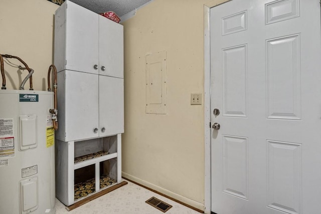 utility room featuring electric water heater and electric panel