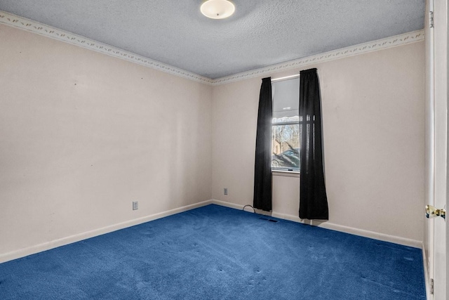 unfurnished room with a textured ceiling and dark carpet