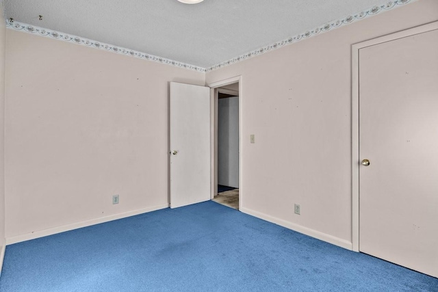 unfurnished bedroom with light carpet and a textured ceiling