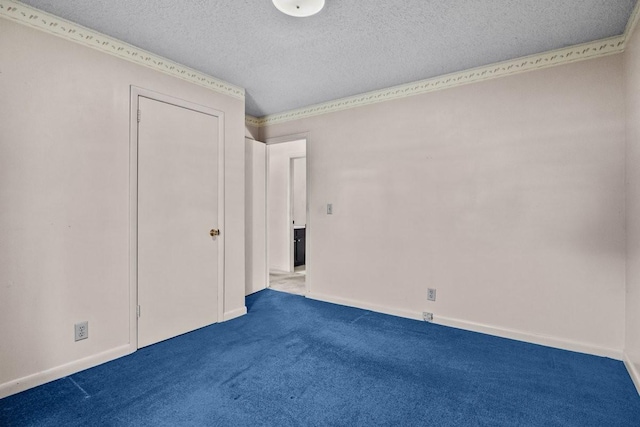 unfurnished bedroom featuring carpet flooring and a textured ceiling