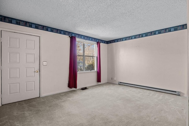 carpeted spare room featuring a textured ceiling and baseboard heating