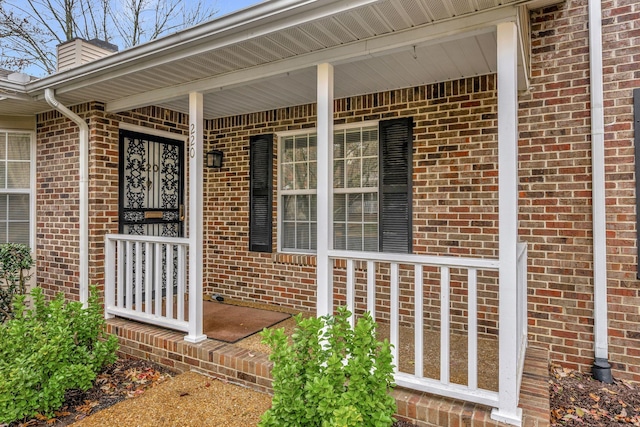 view of exterior entry featuring a porch