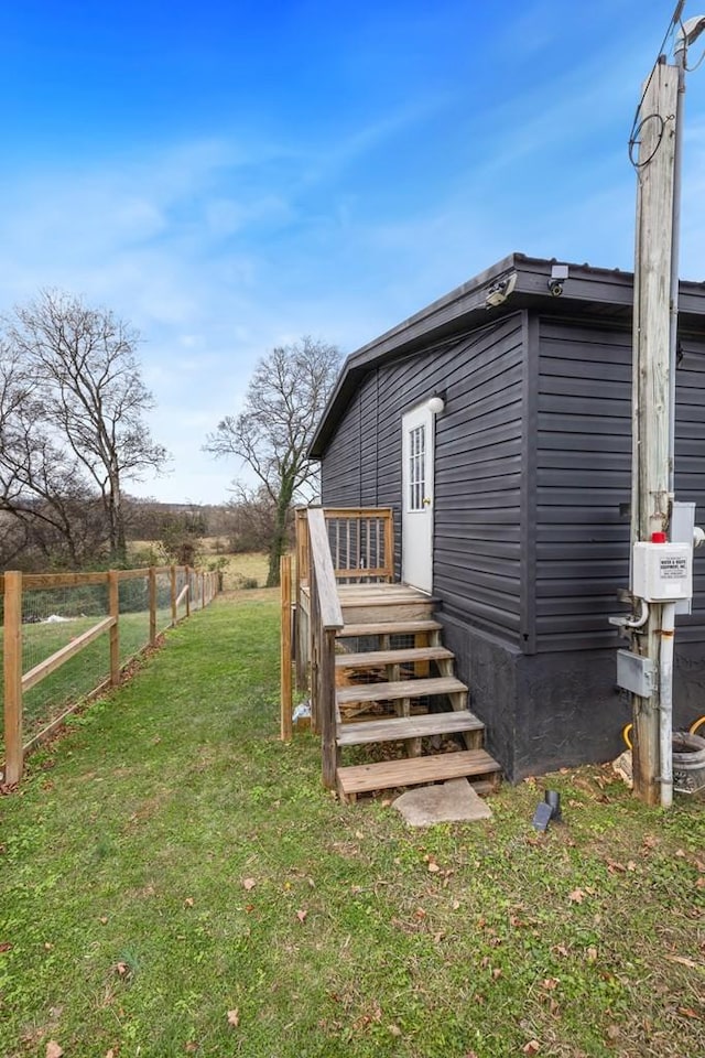 view of side of home featuring a lawn