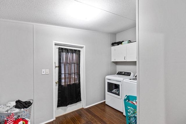 laundry area featuring cabinets, a textured ceiling, dark hardwood / wood-style flooring, and washer and clothes dryer