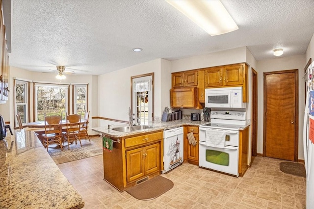 kitchen featuring white appliances, ceiling fan, light stone countertops, a textured ceiling, and kitchen peninsula