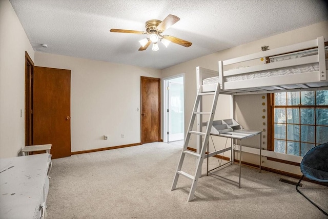 carpeted bedroom with a textured ceiling and ceiling fan