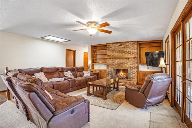 living room featuring french doors, a brick fireplace, a textured ceiling, light colored carpet, and ceiling fan