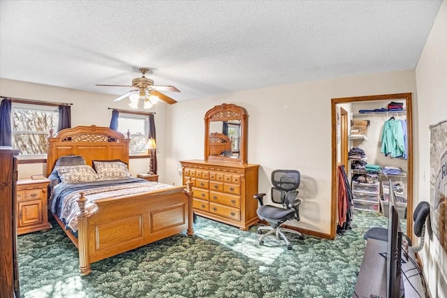 carpeted bedroom featuring a textured ceiling and ceiling fan