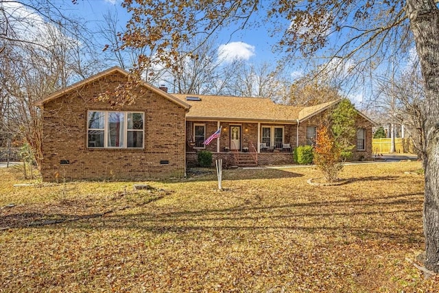 ranch-style home with a porch and a front yard