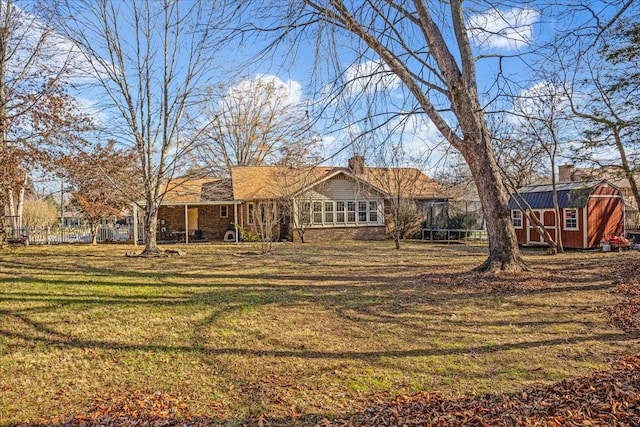 exterior space with a storage unit and a front yard