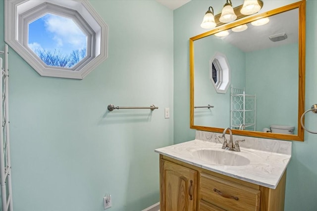 bathroom with vanity and toilet