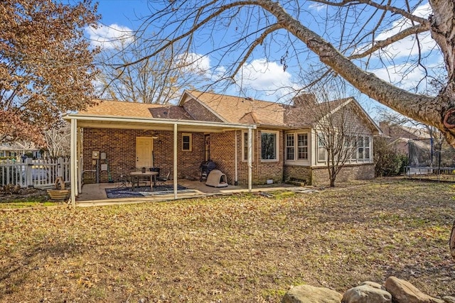 back of house featuring a patio area and a trampoline