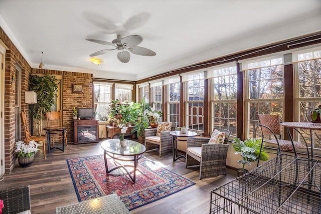 sunroom featuring ceiling fan