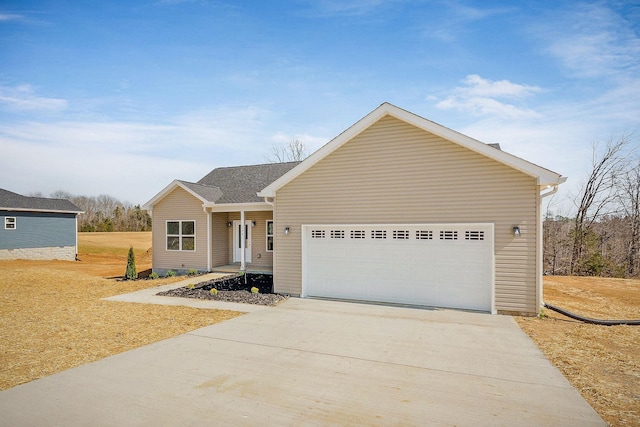 ranch-style home with a garage and driveway