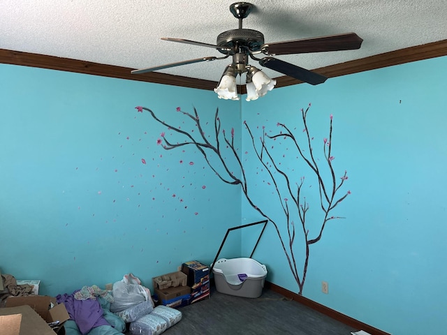 interior space featuring a textured ceiling, dark carpet, ceiling fan, and ornamental molding