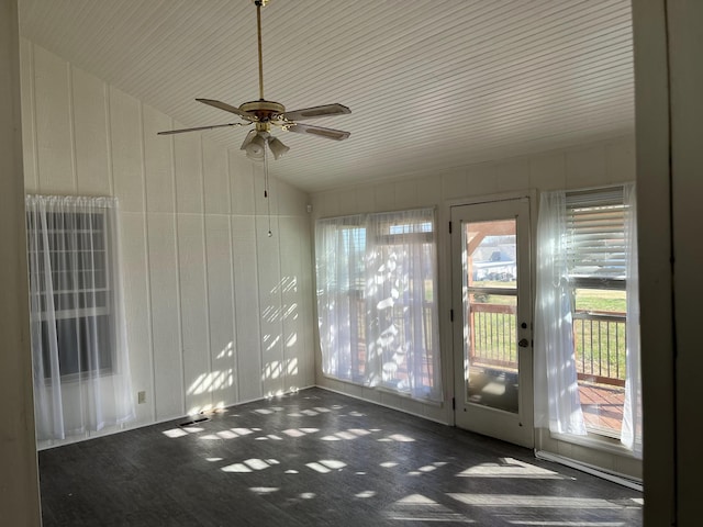 unfurnished sunroom featuring ceiling fan and vaulted ceiling