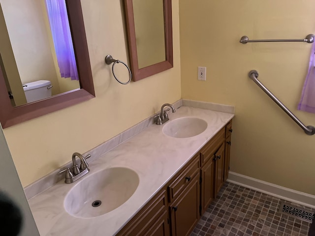 bathroom featuring vanity and toilet