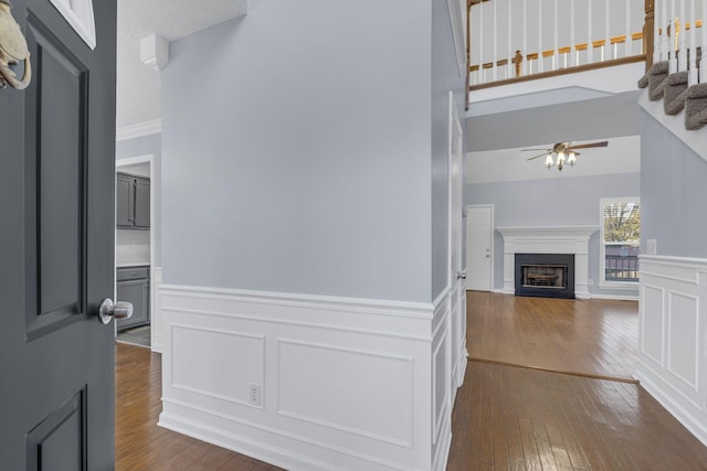 corridor with dark wood-type flooring and a high ceiling