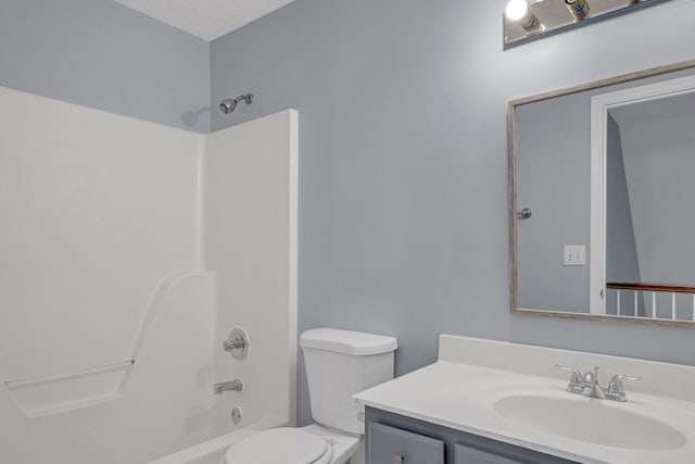 full bathroom featuring vanity,  shower combination, toilet, and a textured ceiling