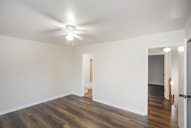 spare room featuring ornamental molding, ceiling fan, and dark wood-type flooring