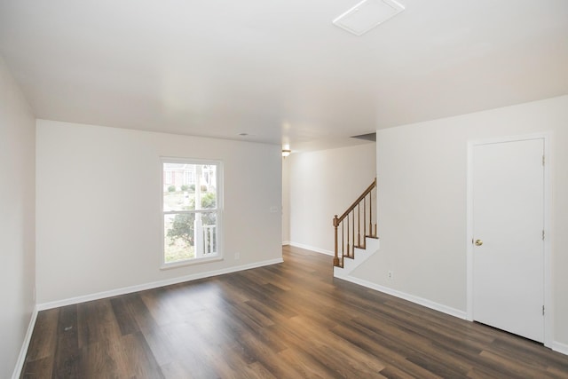 spare room with dark wood-type flooring