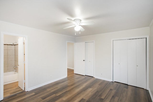 unfurnished bedroom with connected bathroom, ceiling fan, crown molding, and dark wood-type flooring